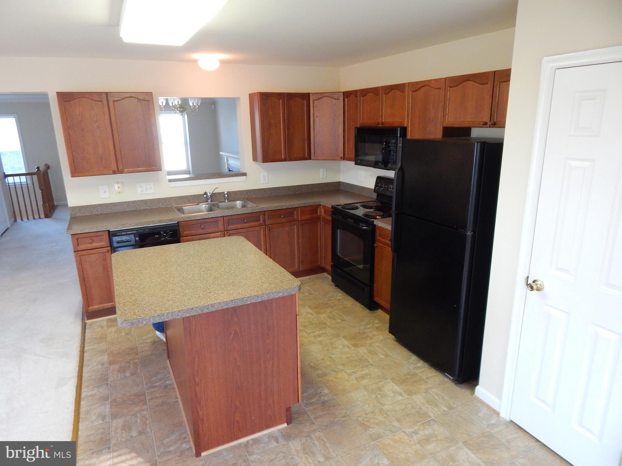 124 Raphael Court Martinsburg, WV 25403 - Photo 9 of 30 a kitchen with stainless steel appliances granite countertop a refrigerator a stove and a microwave