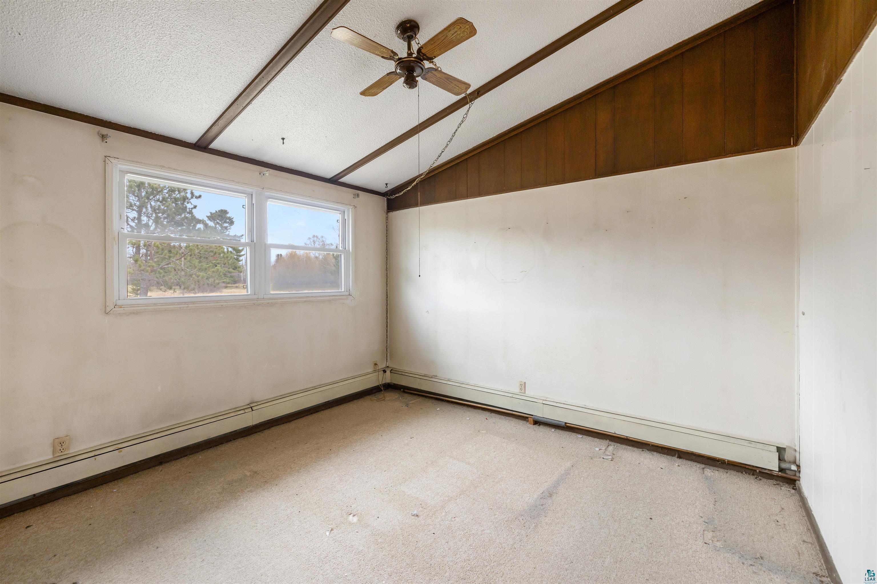 11574 Town Line Road Hibbing, MN 55746 - Photo 11 of 41 Room featuring sloped ceilings with exposed wood beams, a ceiling fan, and large windows