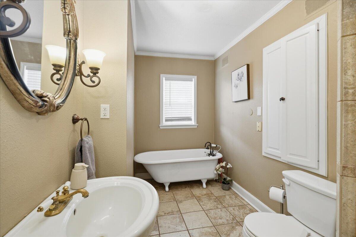 2702 20th Street Lubbock, TX 79410 - Photo 16 of 34 a bathroom with a sink and a mirror