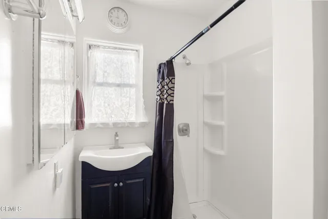 a living room with furniture pool table and a flat screen tv