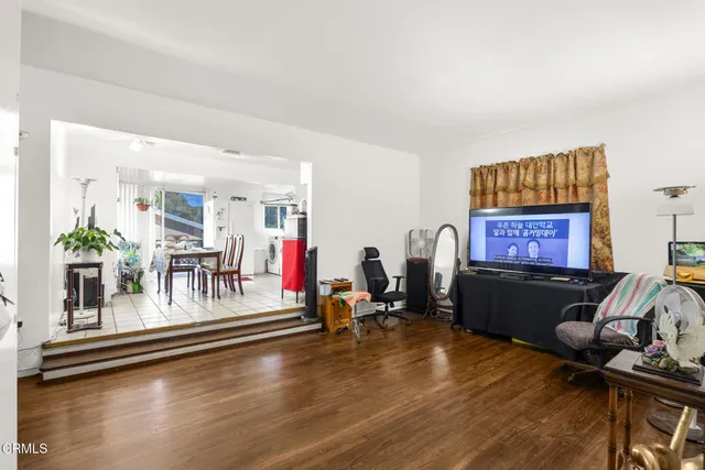 a living room with hard wood floors and a table