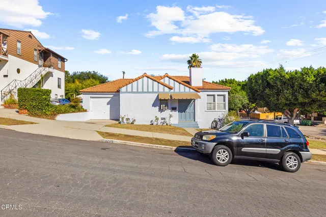 a view of a car parked in front of a house