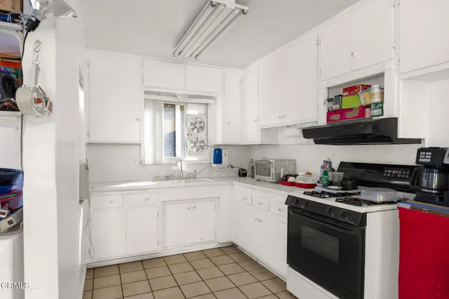 a kitchen with stainless steel appliances granite countertop a stove and a refrigerator