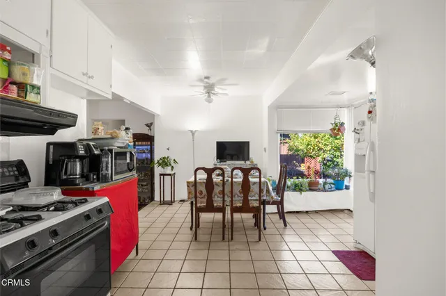 a view of a dining room with furniture and a chandelier