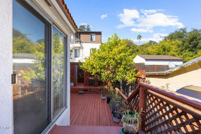 a view of a balcony with chairs and wooden floor