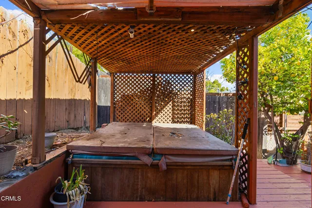 a view of a balcony with chairs and wooden floor