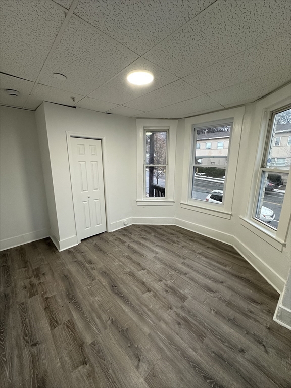 126 Lincoln Street, Unit 1L Worcester, MA 01605 - Photo 10 of 10 an empty room with wooden floor and windows