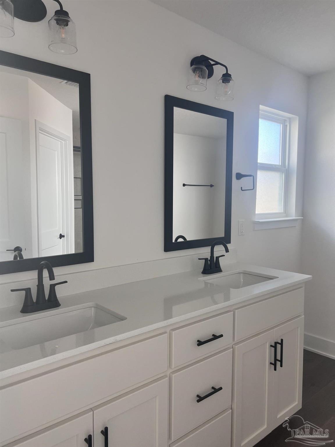 5232 Muscadine Way Milton, FL 32570 - Photo 11 of 23 a bathroom with double sink and a mirror