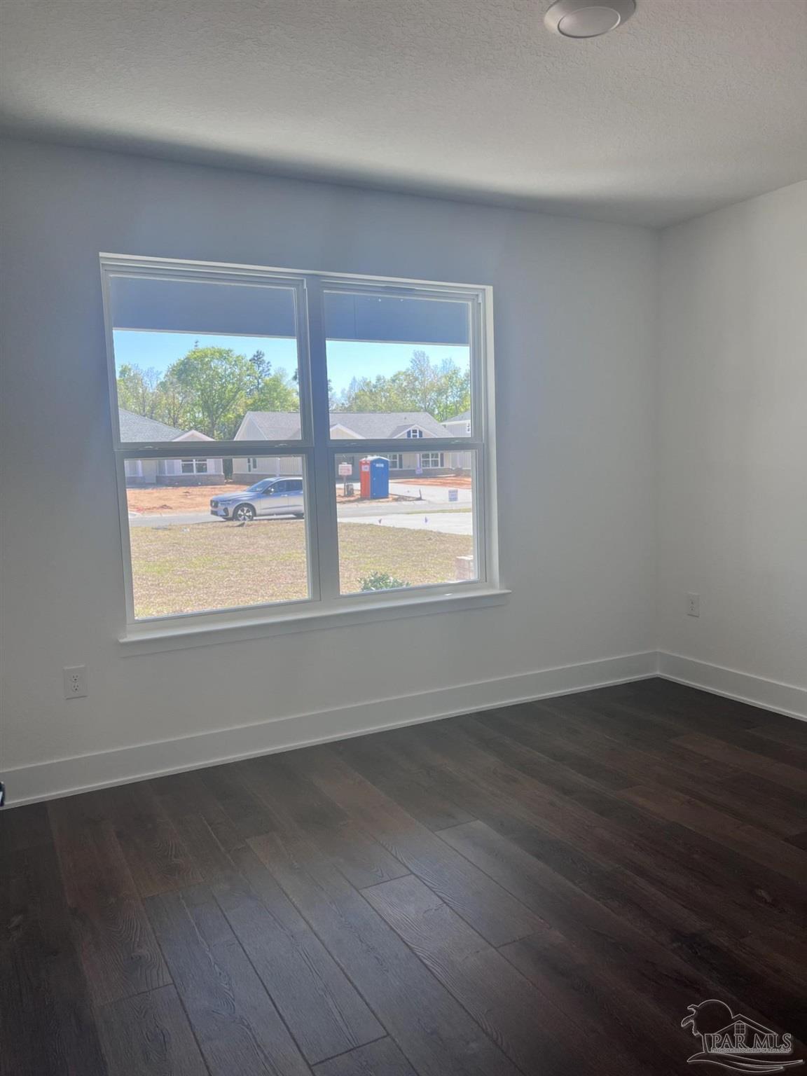 5232 Muscadine Way Milton, FL 32570 - Photo 16 of 23 a view of an empty room with wooden floor and a window