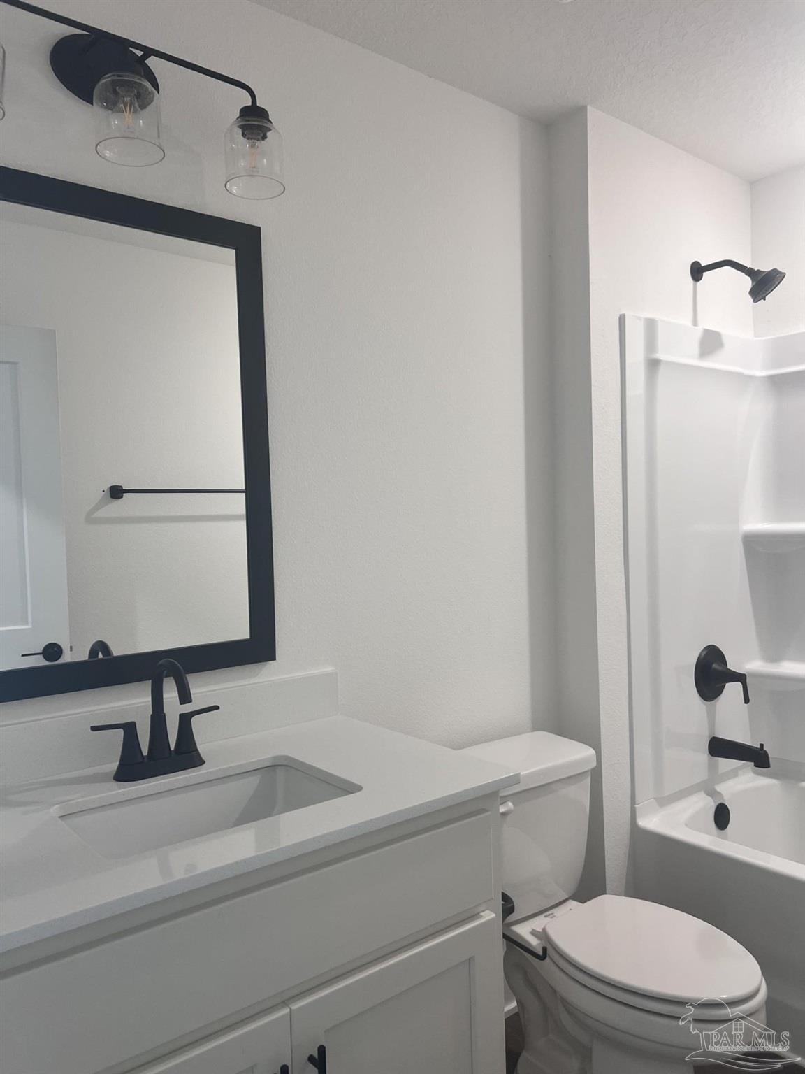 5232 Muscadine Way Milton, FL 32570 - Photo 18 of 23 a bathroom with a sink a toilet and mirror
