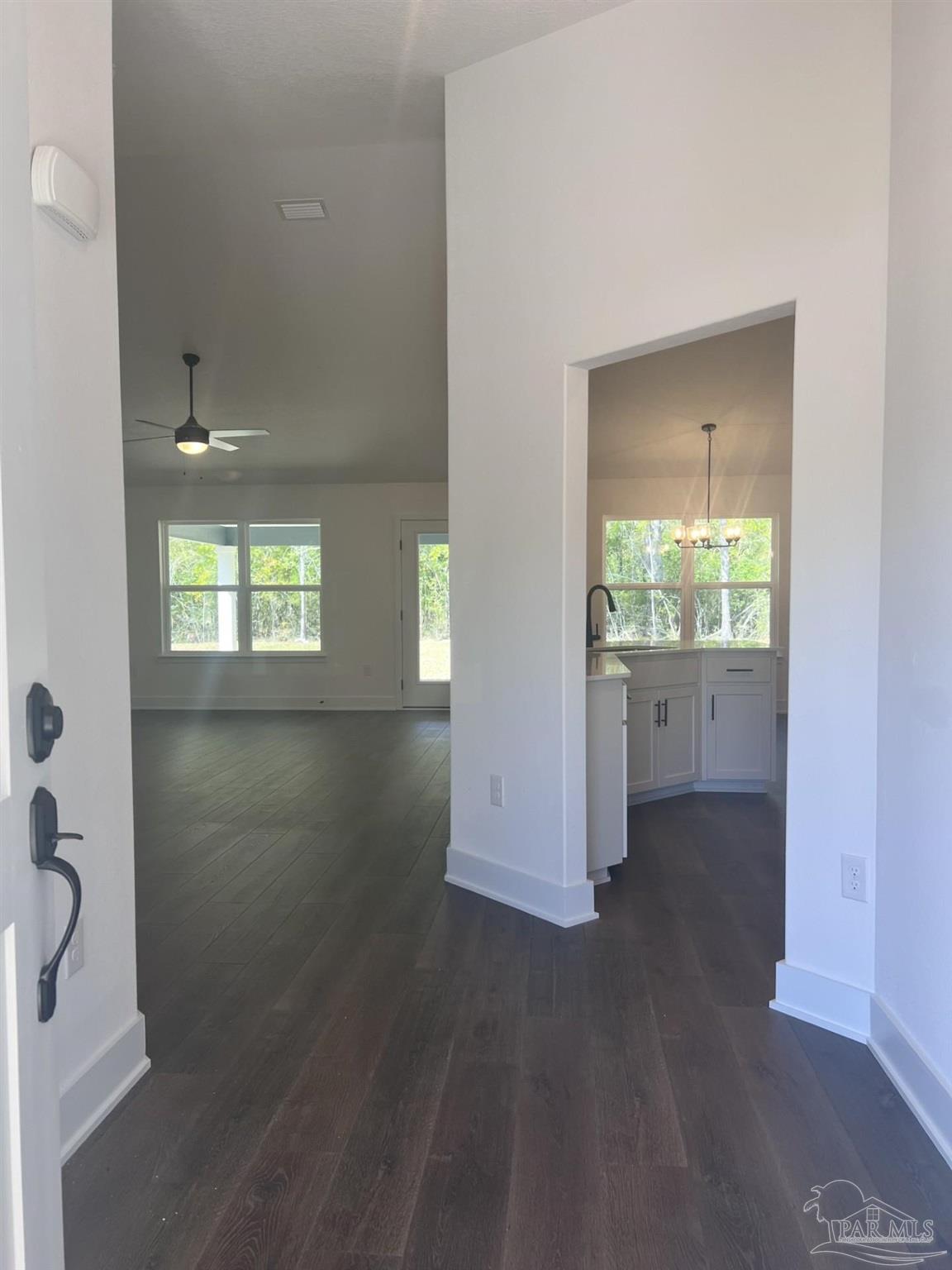 5232 Muscadine Way Milton, FL 32570 - Photo 3 of 23 an empty room with wooden floor and windows