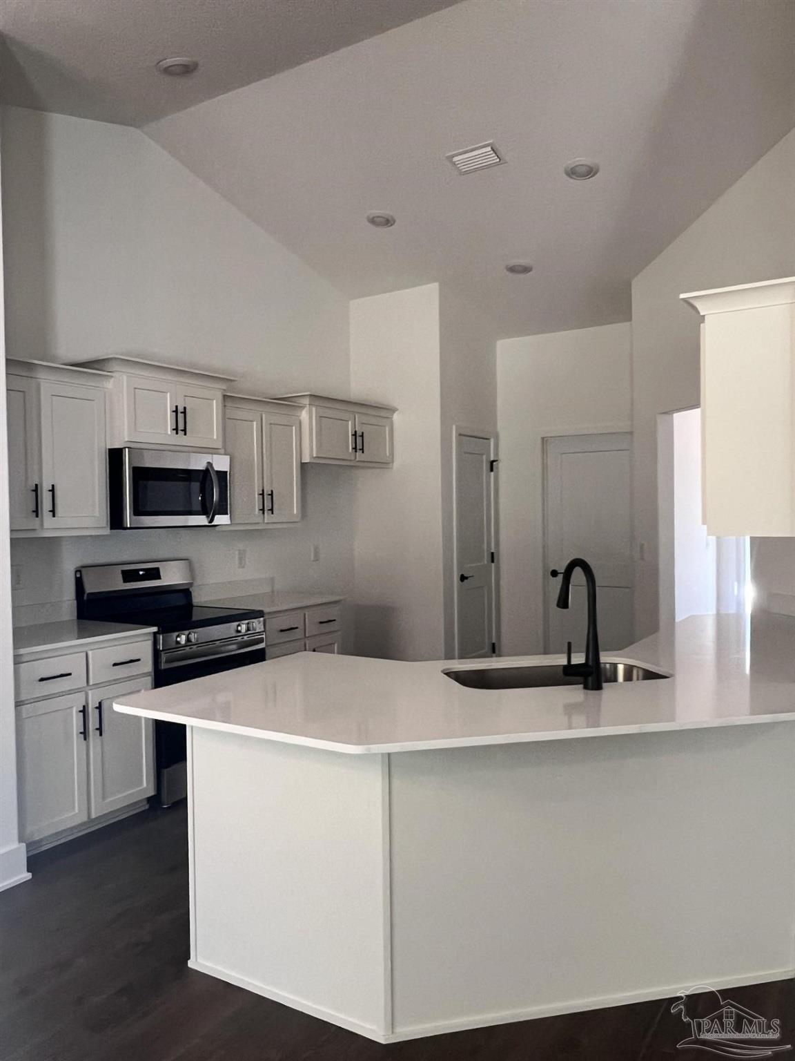 5232 Muscadine Way Milton, FL 32570 - Photo 6 of 23 a kitchen with stainless steel appliances granite countertop a sink a stove top oven a counter space and cabinets