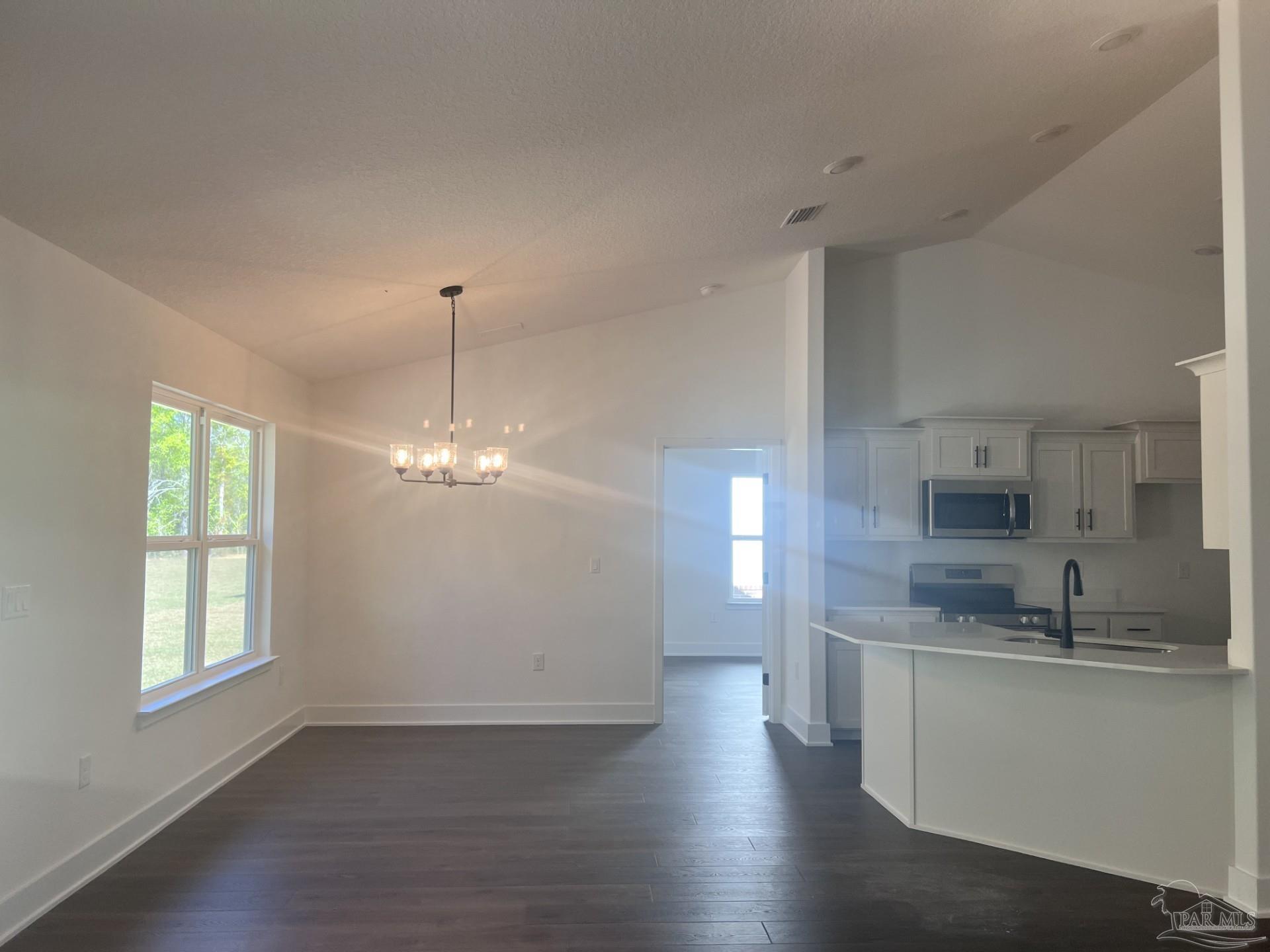 5232 Muscadine Way Milton, FL 32570 - Photo 7 of 23 a view of a kitchen with granite countertop cabinets a sink and a dishwasher