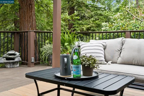 a view of a balcony with chairs and a potted plant