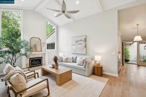 a living room with furniture fireplace and flat screen tv