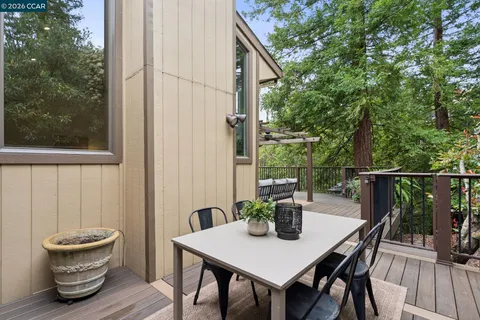 a view of a deck with table and chairs and wooden floor