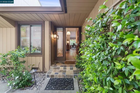 a view of a entrance to house with potted plants