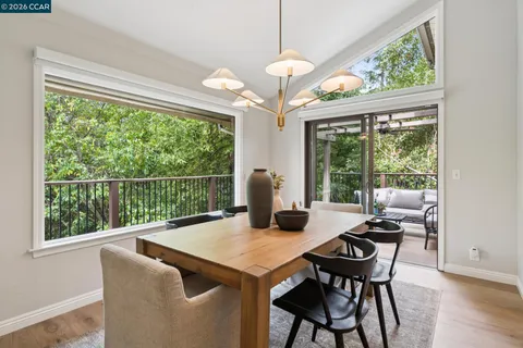 a view of a dining room with furniture large windows and wooden floor
