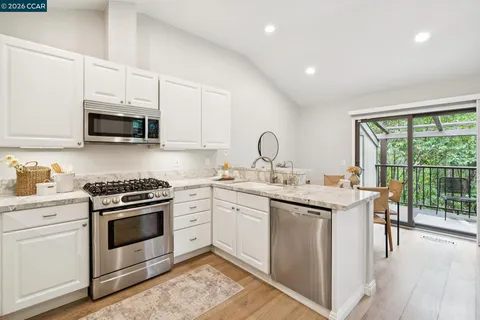 a kitchen with a stove sink and microwave