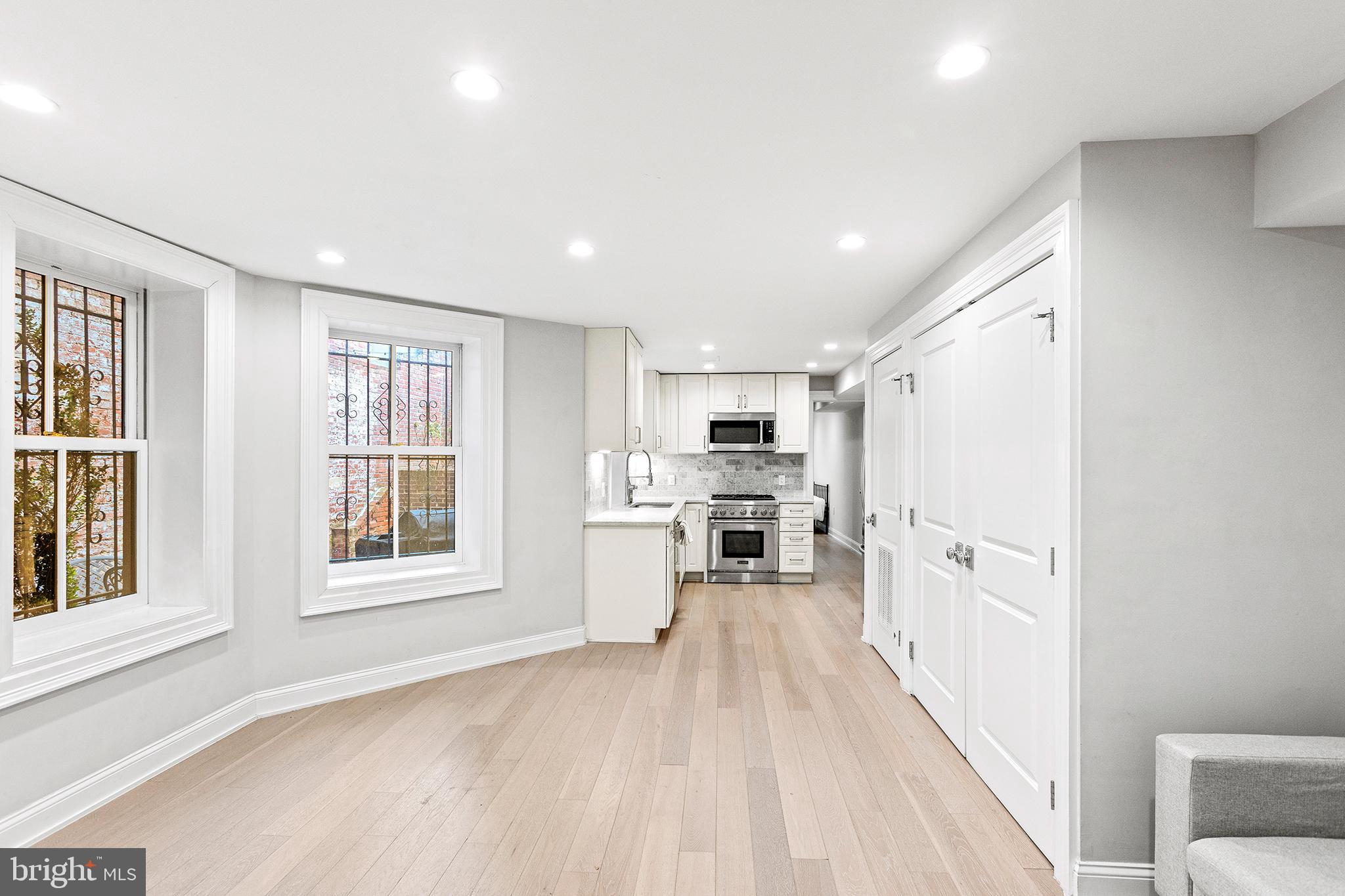 1330 Vermont Avenue Northwest, Unit 2 Washington, DC 20005 - Photo 1 of 17 a view of a kitchen with a sink and dishwasher a refrigerator with white cabinets