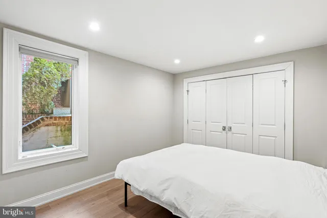 a bedroom with a large bed and a window