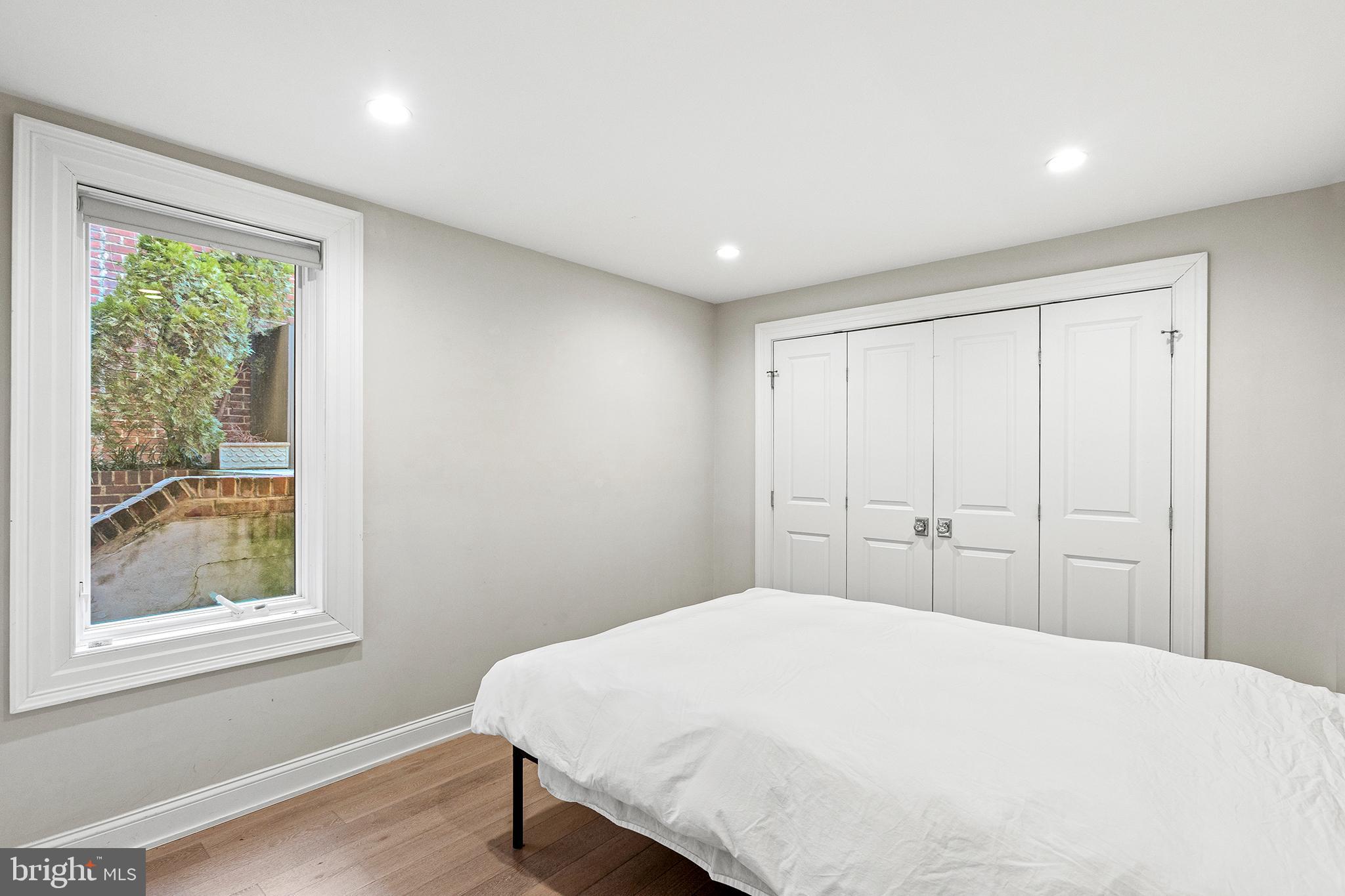 1330 Vermont Avenue Northwest, Unit 2 Washington, DC 20005 - Photo 13 of 17 a bedroom with a large bed and a window