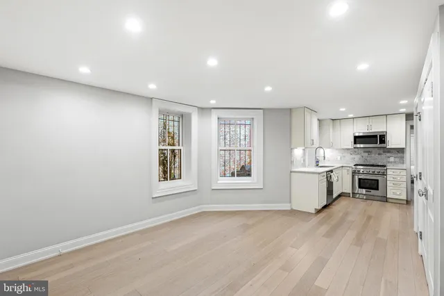 a view of kitchen with sink and wooden floor