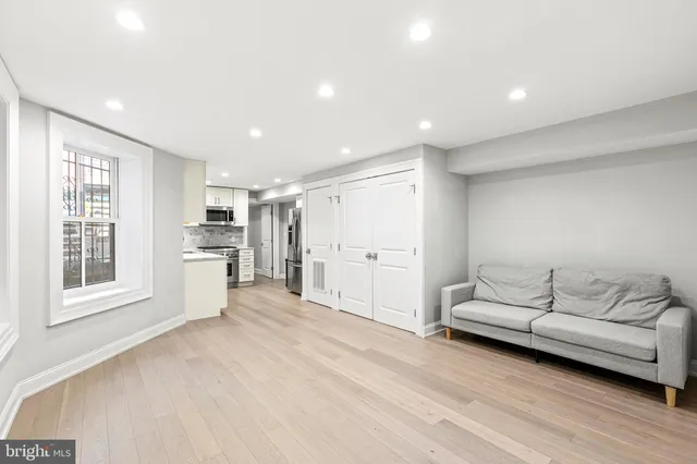 a spacious bedroom with a bed and a large window