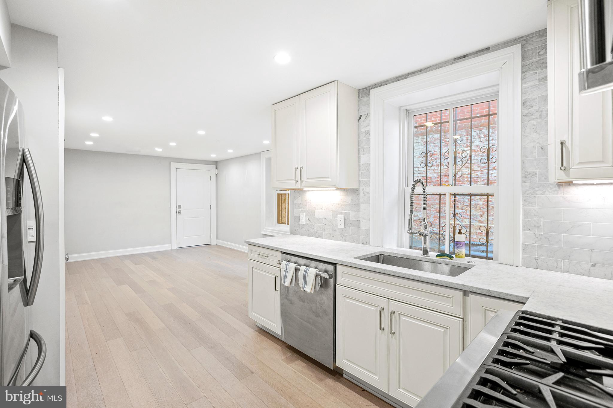 1330 Vermont Avenue Northwest, Unit 2 Washington, DC 20005 - Photo 7 of 17 a kitchen with stainless steel appliances granite countertop a sink stove and refrigerator