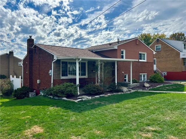 a backyard of a house with yard and outdoor seating