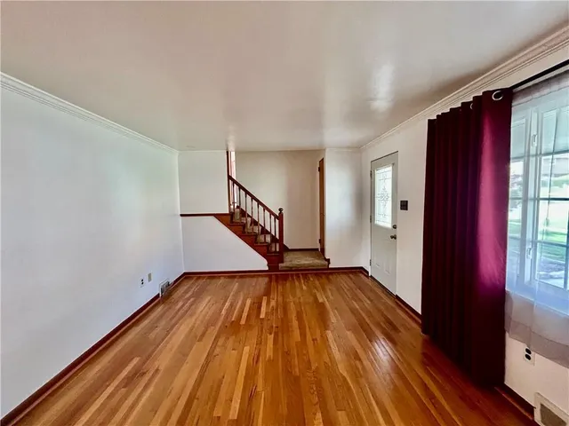 a view of room with window and wooden floor