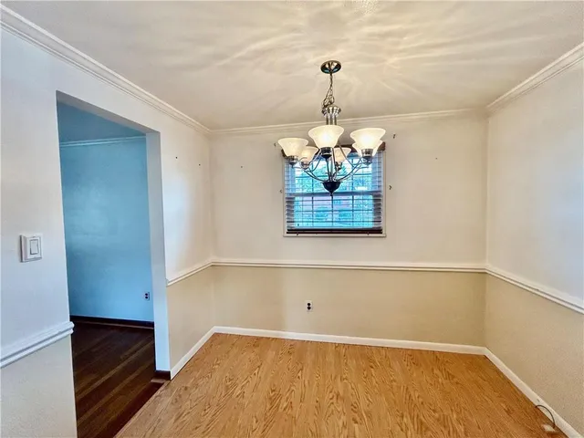 a view of a livingroom with a chandelier furniture and a ceiling fan