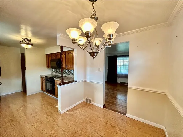 a kitchen with stainless steel appliances a refrigerator and a stove top oven
