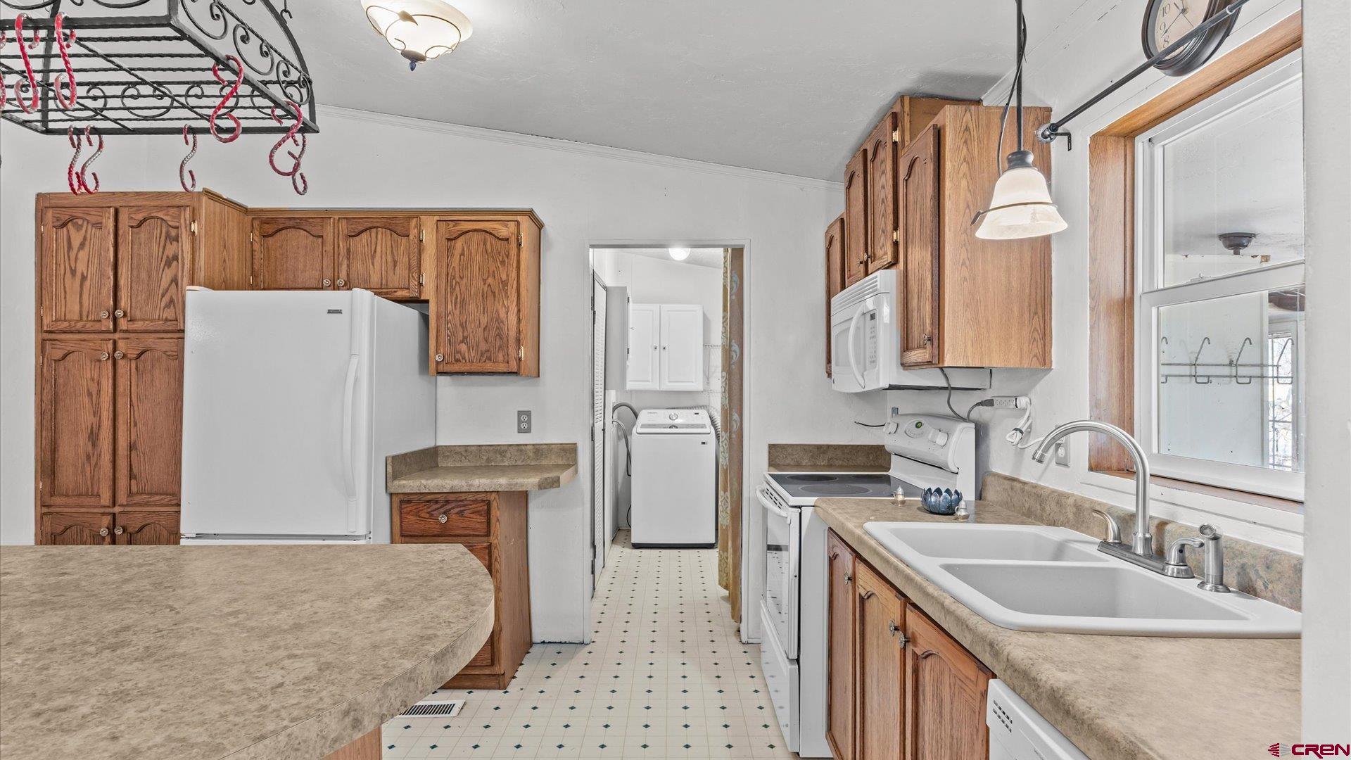 777 1550th Road Delta, CO 81416 - Photo 12 of 32 a kitchen with a refrigerator and a sink