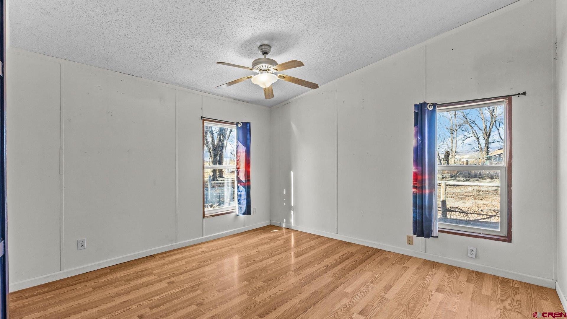 777 1550th Road Delta, CO 81416 - Photo 14 of 32 a view of an empty room with window and wooden floor