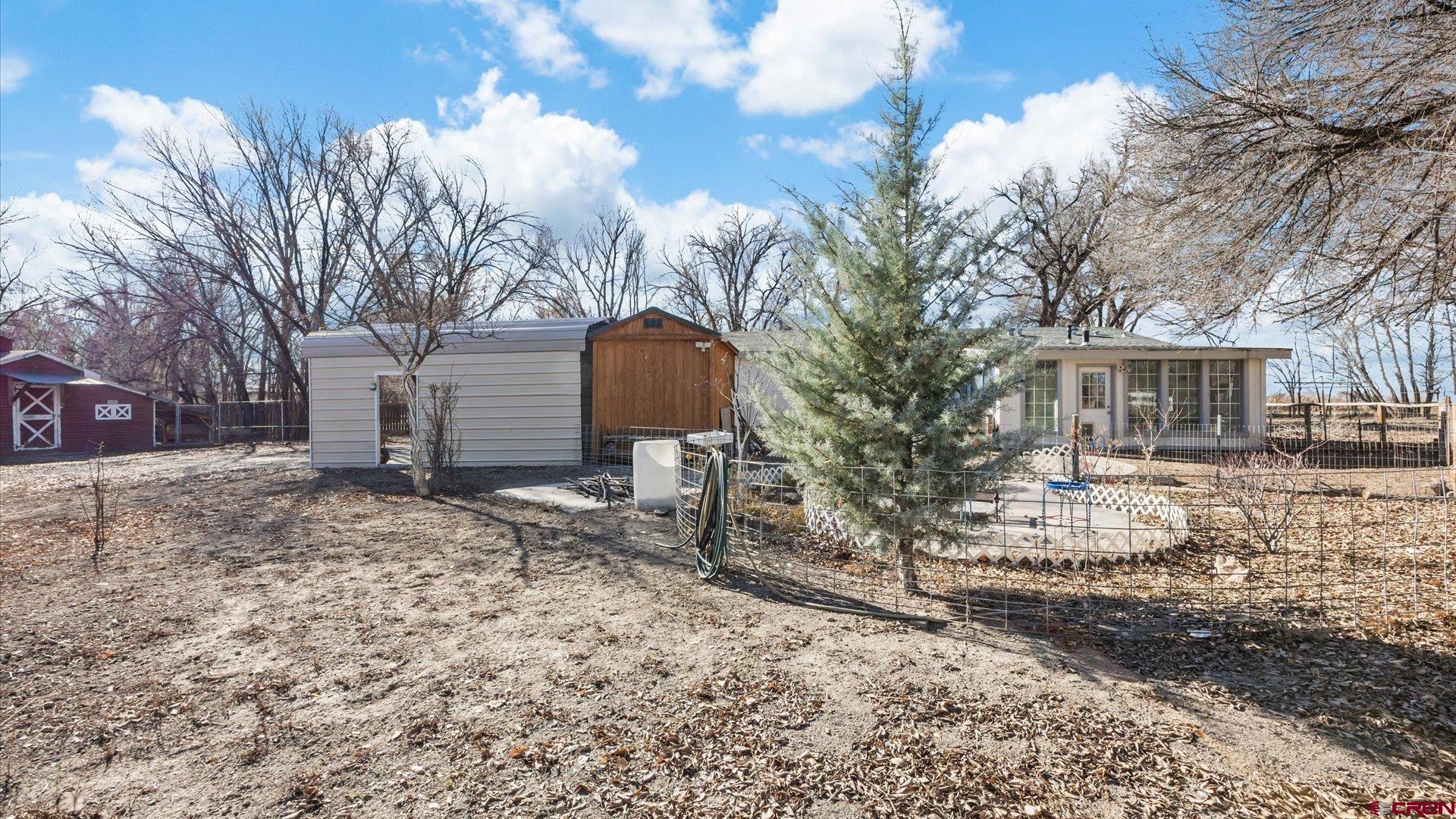 777 1550th Road Delta, CO 81416 - Photo 27 of 32 a backyard of a house with large trees and outdoor space