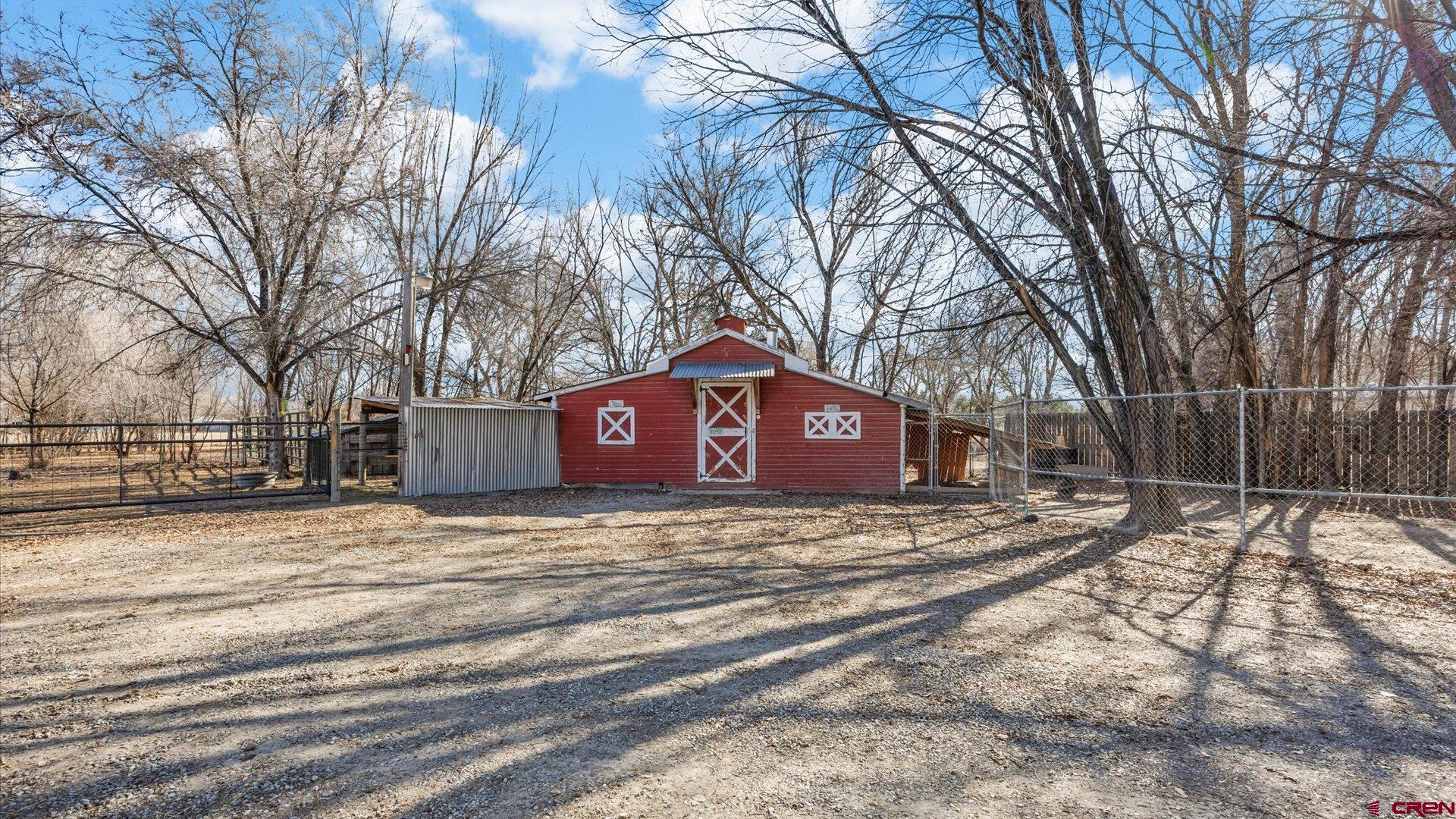 777 1550th Road Delta, CO 81416 - Photo 28 of 32 a large house with a large tree in front of it