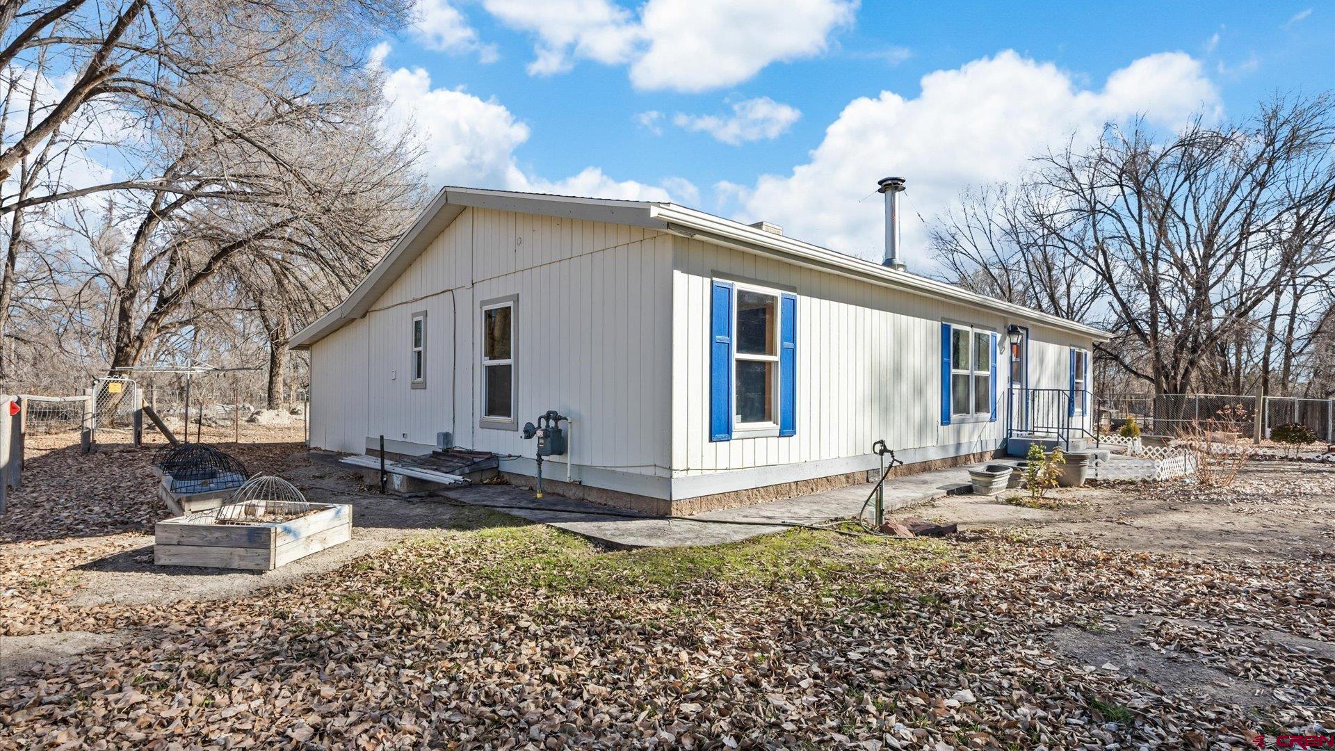 777 1550th Road Delta, CO 81416 - Photo 3 of 32 a front view of a house with garden