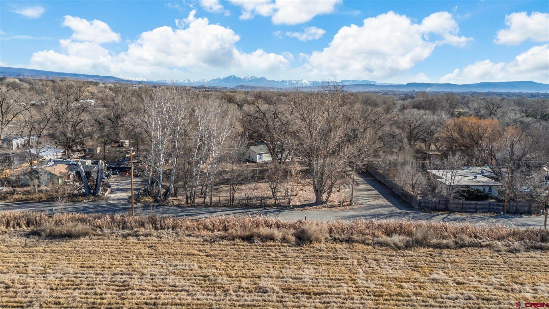 777 1550th Road Delta, CO 81416 - Photo 4 of 32 a view of a dry yard with wooden fence