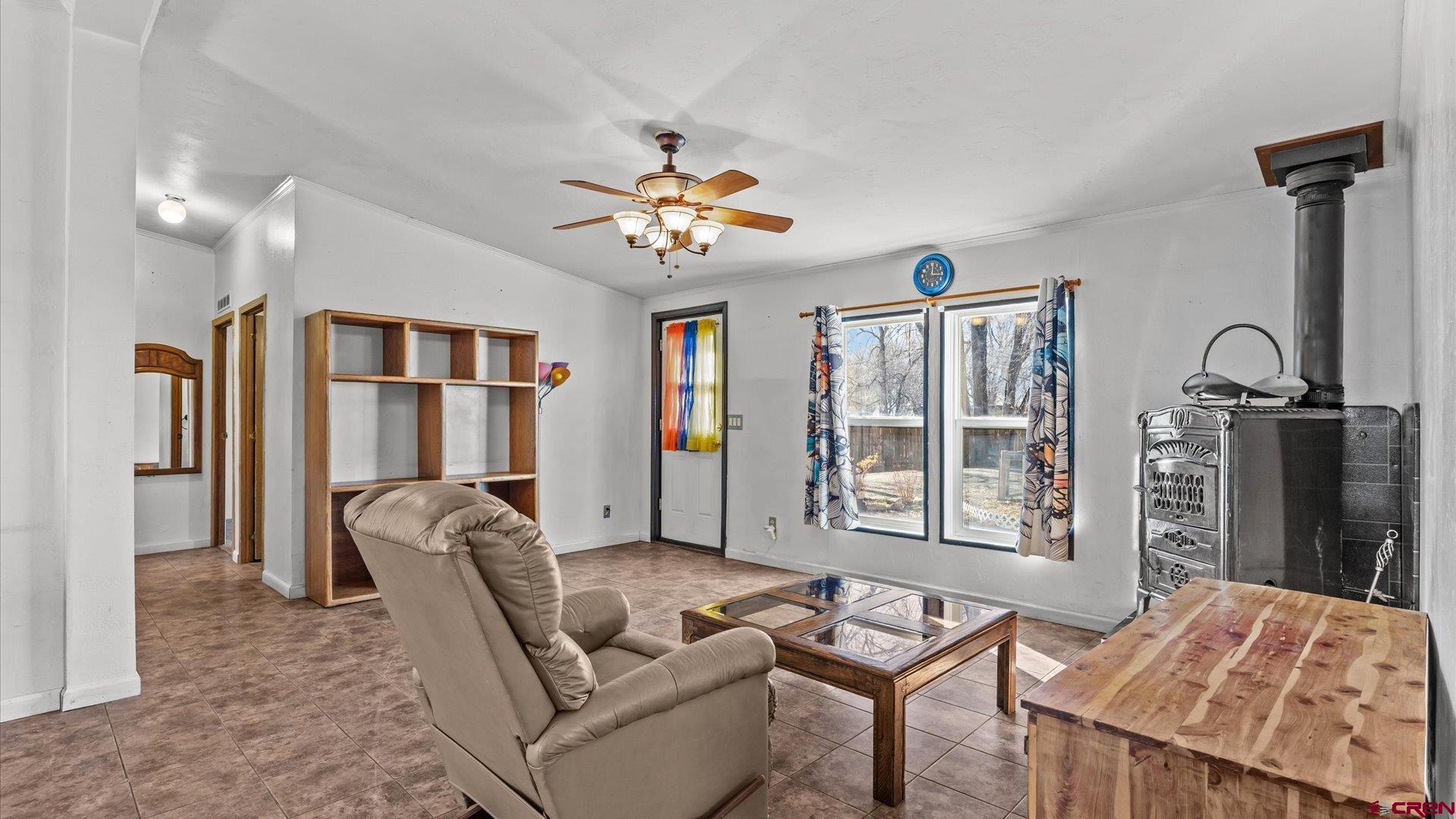 777 1550th Road Delta, CO 81416 - Photo 8 of 32 a living room with furniture a ceiling fan and a window