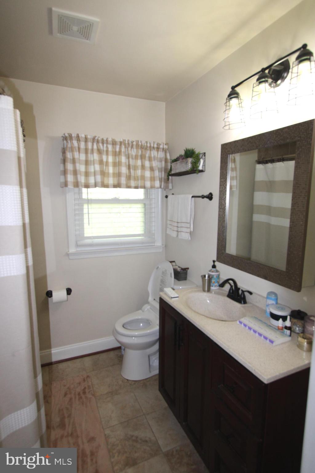 7802 Shelbourne Road Baltimore, MD 21226 - Photo 11 of 19 a bathroom with a sink toilet and mirror