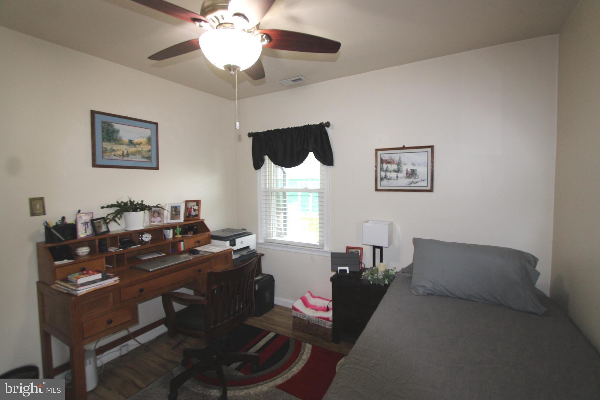 7802 Shelbourne Road Baltimore, MD 21226 - Photo 13 of 19 a living room with furniture a chandelier and a window