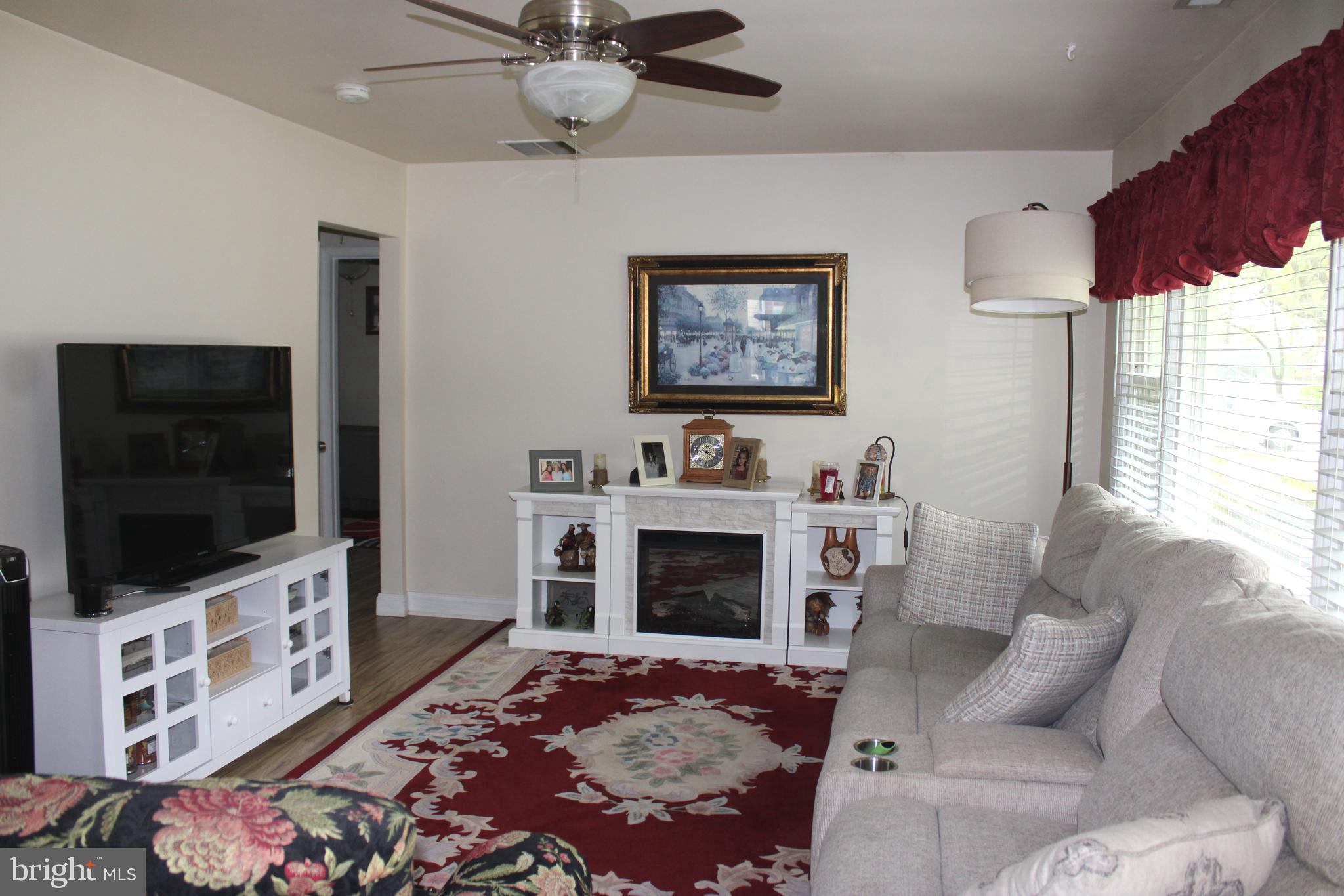 7802 Shelbourne Road Baltimore, MD 21226 - Photo 3 of 19 a living room with furniture and a flat screen tv