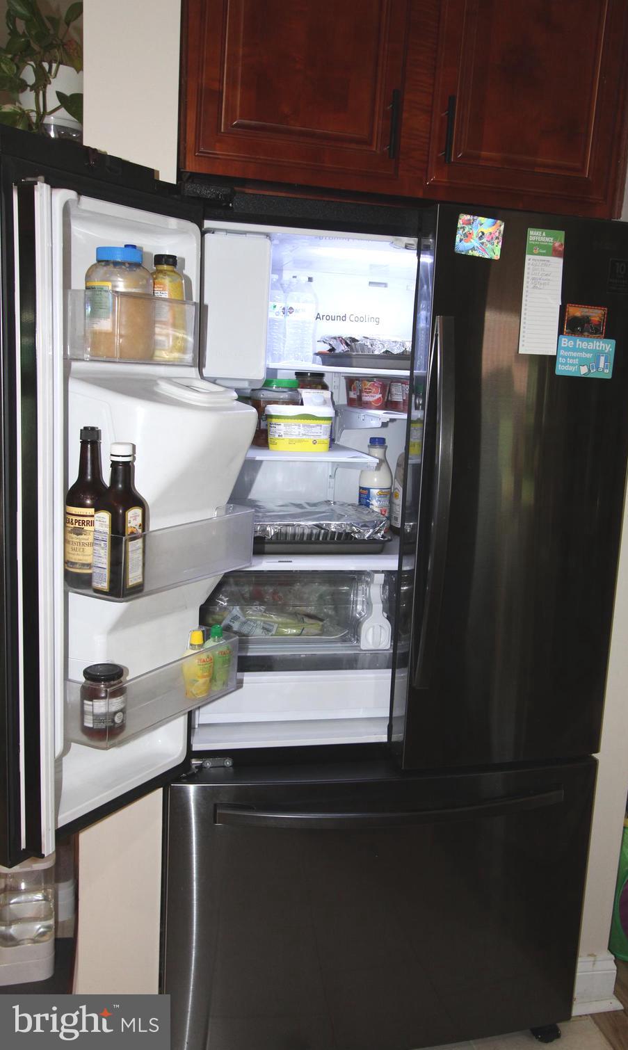 7802 Shelbourne Road Baltimore, MD 21226 - Photo 5 of 19 a kitchen with stainless steel appliances a refrigerator and a stove