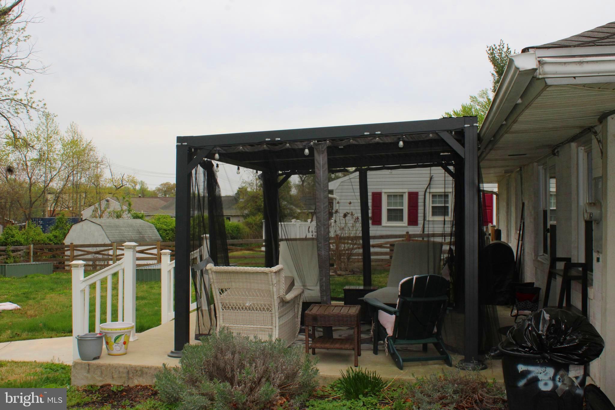 7802 Shelbourne Road Baltimore, MD 21226 - Photo 9 of 19 a front view of a house with outdoor seating