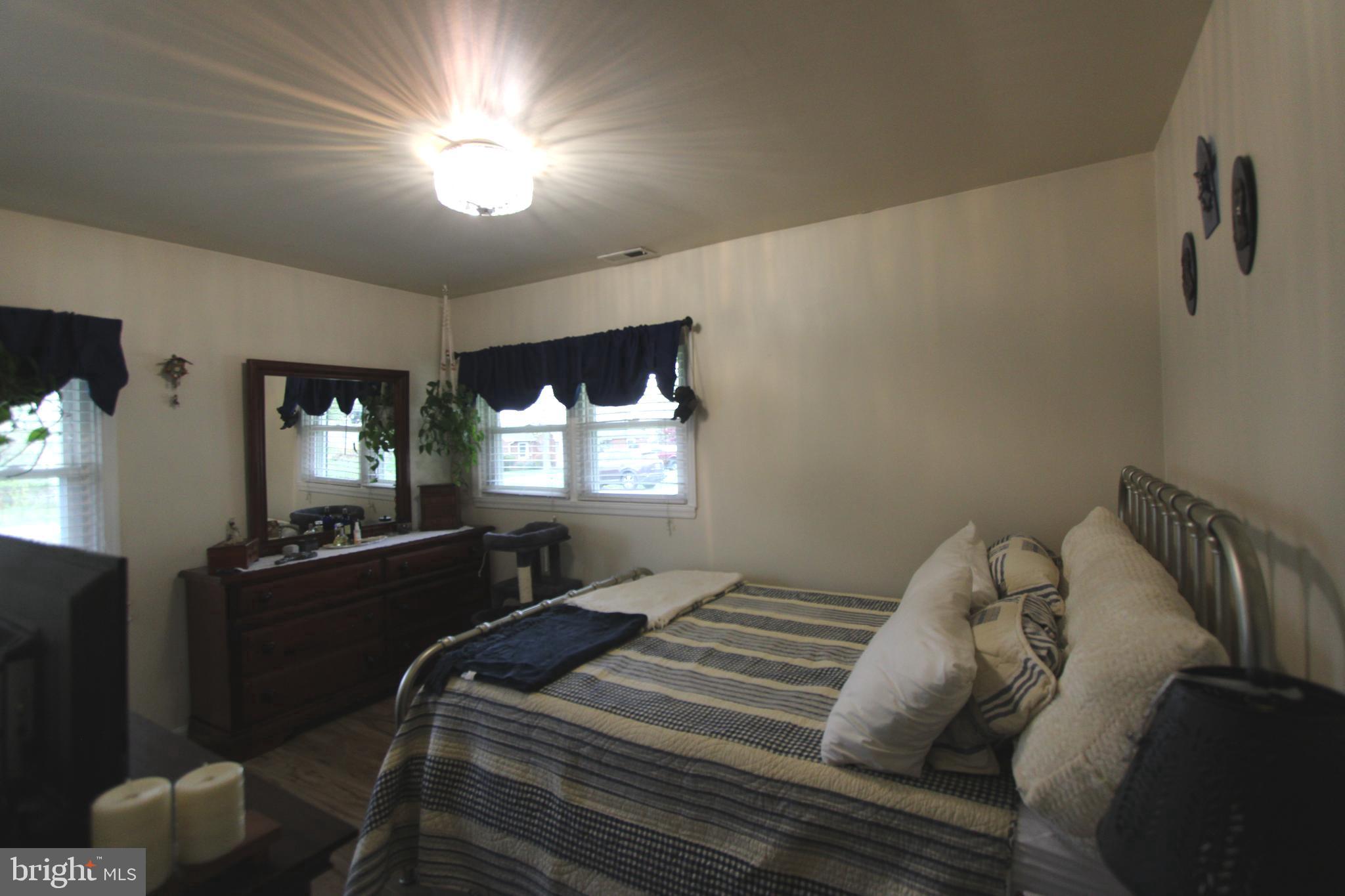 7802 Shelbourne Road Baltimore, MD 21226 - Photo 10 of 19 a bedroom with a bed and window