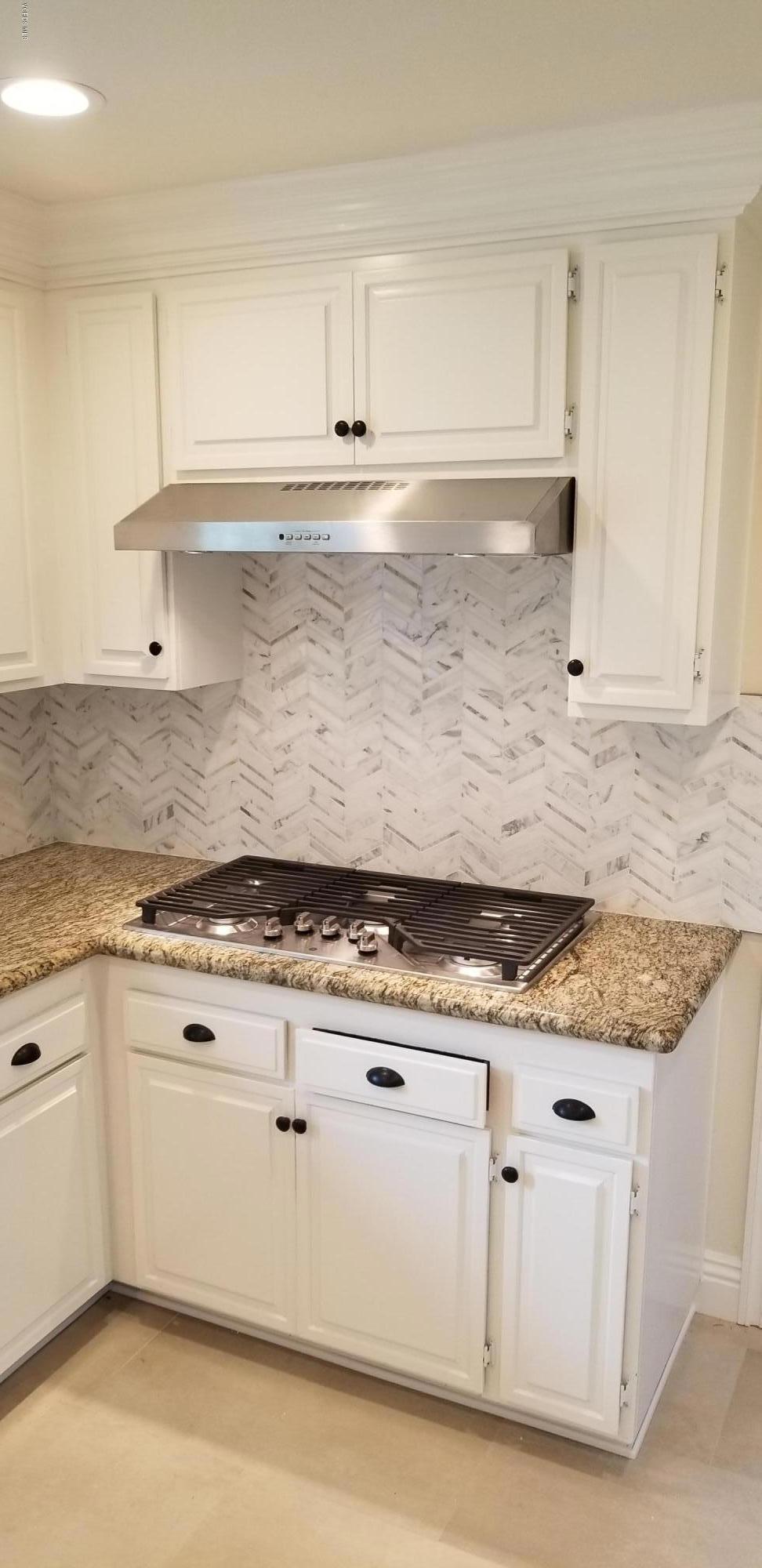 211 Windtree Avenue Thousand Oaks, CA 91320 - Photo 4 of 29 a white kitchen with granite countertop white cabinets and a granite counter tops