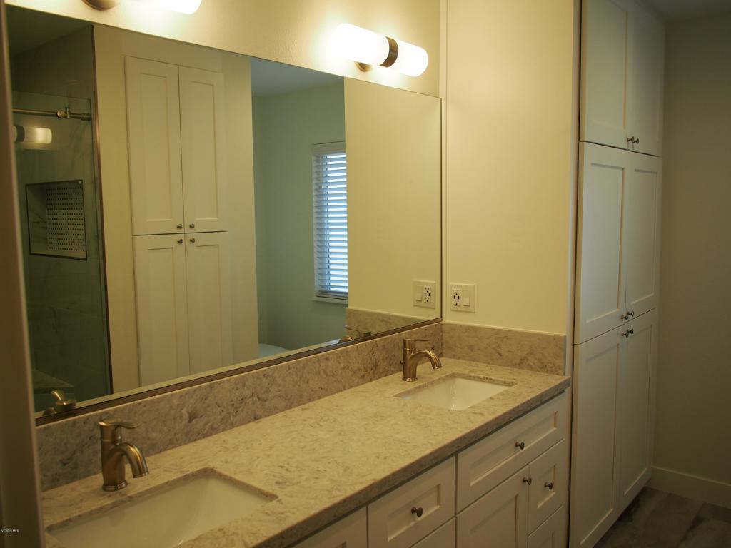 211 Windtree Avenue Thousand Oaks, CA 91320 - Photo 10 of 29 a bathroom with a granite countertop sink and a mirror