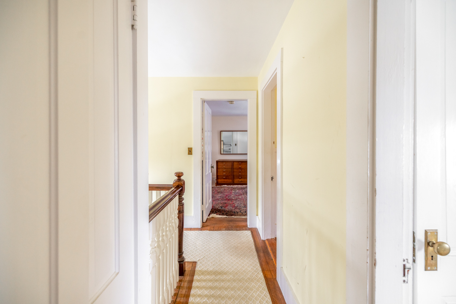 35 West Chester Street Nantucket, MA 02554 - Photo 10 of 14 a hallway with wooden floor and a bathroom