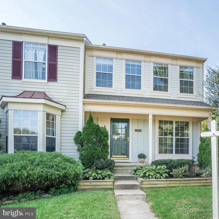 front view of a brick house with a yard